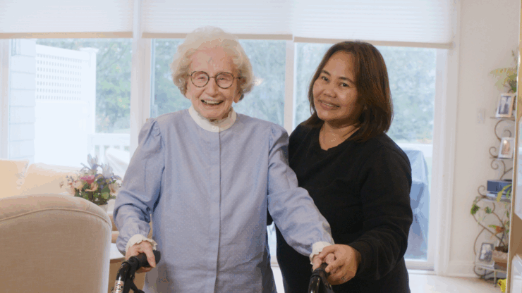 Ecstatic smiling senior woman with her smiling caregiver, enjoying companionship