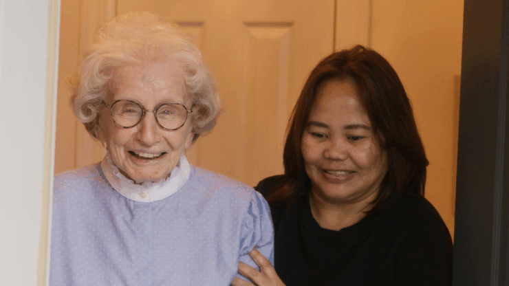Smiling senior with her in-home caregiver