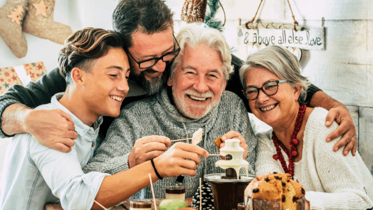 Family gathering around a table with fondue, smiling joyfully. The scene is warm and festive, with cozy decor and holiday treats.