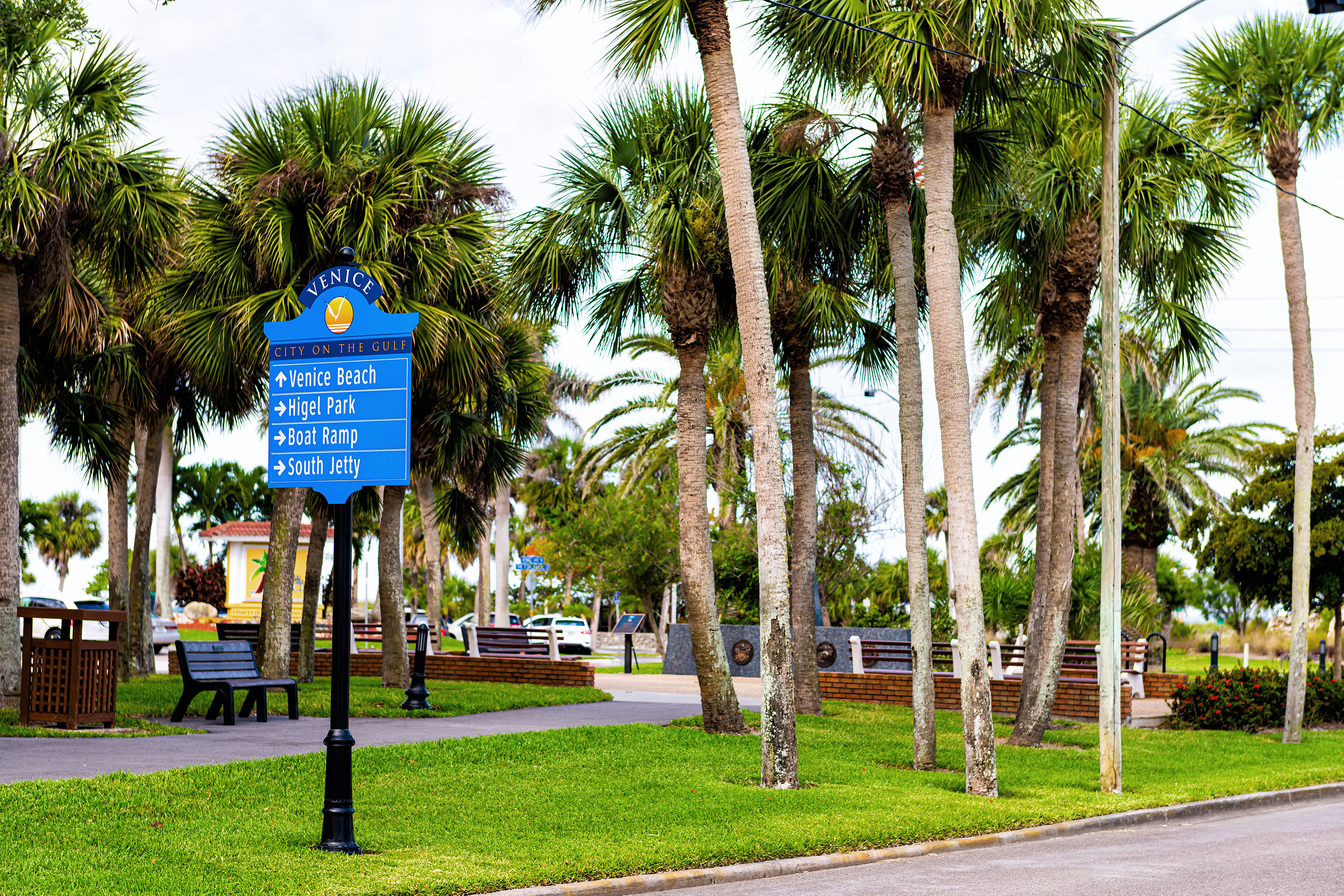 Directional sign in downtown Venice, Florida pointing to beach, theatre, cultural campus, and fishing pier.
